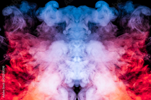 A background of blue, red and purple wavy smoke in the shape of a ghost's head or a man of mystical appearance on a black isolated ground. Bright abstract pattern of steam from vape. © Aleksandr Kondratov