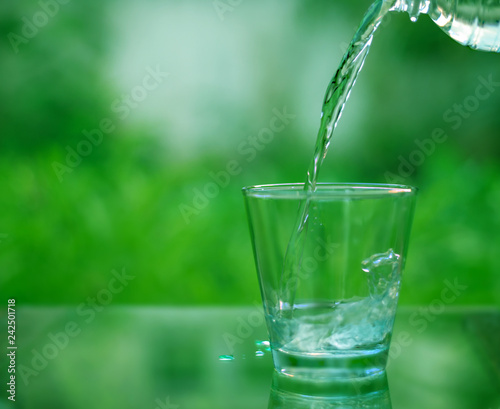 Drinking water in a glass on a wooden table