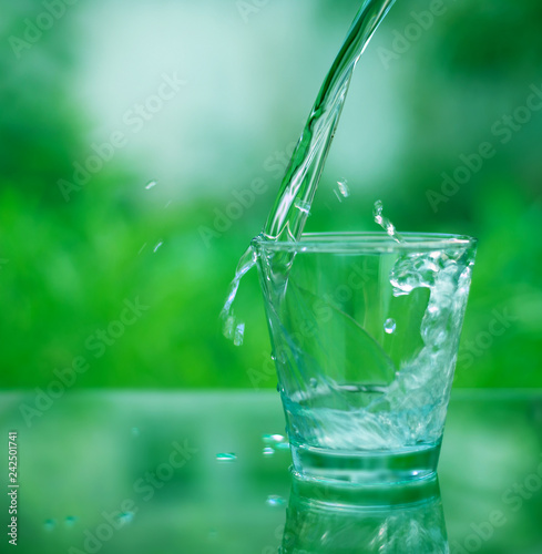 Drinking water in a glass on a wooden table