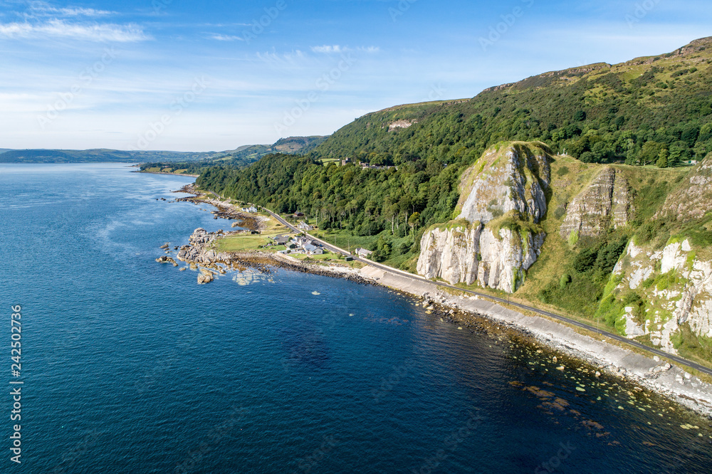Garron Point in Northern Ireland, UK. A geological formation, parking and marina at Antrim Coast Road, a.k.a. Giants Causeway Coastal Route. One of the most scenic coastal roads in Europe. Aerial view