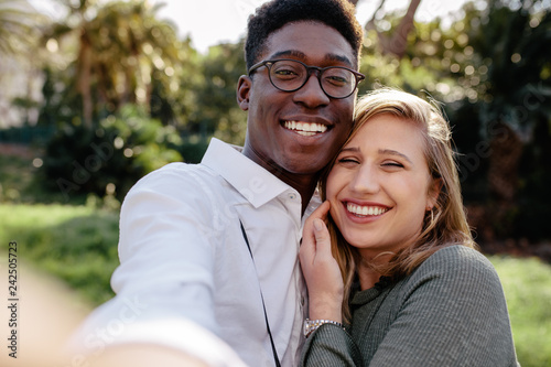 Beautiful interracial couple making a selfie photo