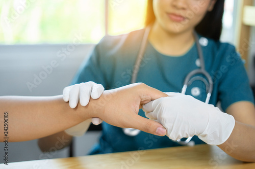 Doctor hand Physicist physical therapy treatment patient in the clinic.Orthopedic medical exam in doctor's hospital office Partnership, traumatology and medical consultation for hand wrist injury photo