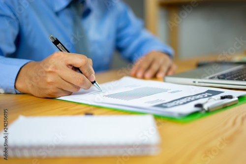 Business person Signing Contract about insurance, men writing with pen sign of modest agreements form In modern office, morning light, vintage color, success of business partners concept