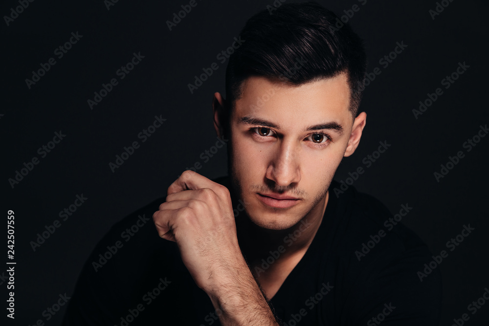 Handsome man, male portrait, black background