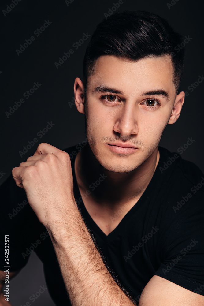 Handsome man, male portrait, black background