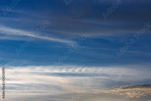 Feathery curls Kelvin-Helmholtz. Kelvin, Helmholtz instability clouds wavy on blue sky