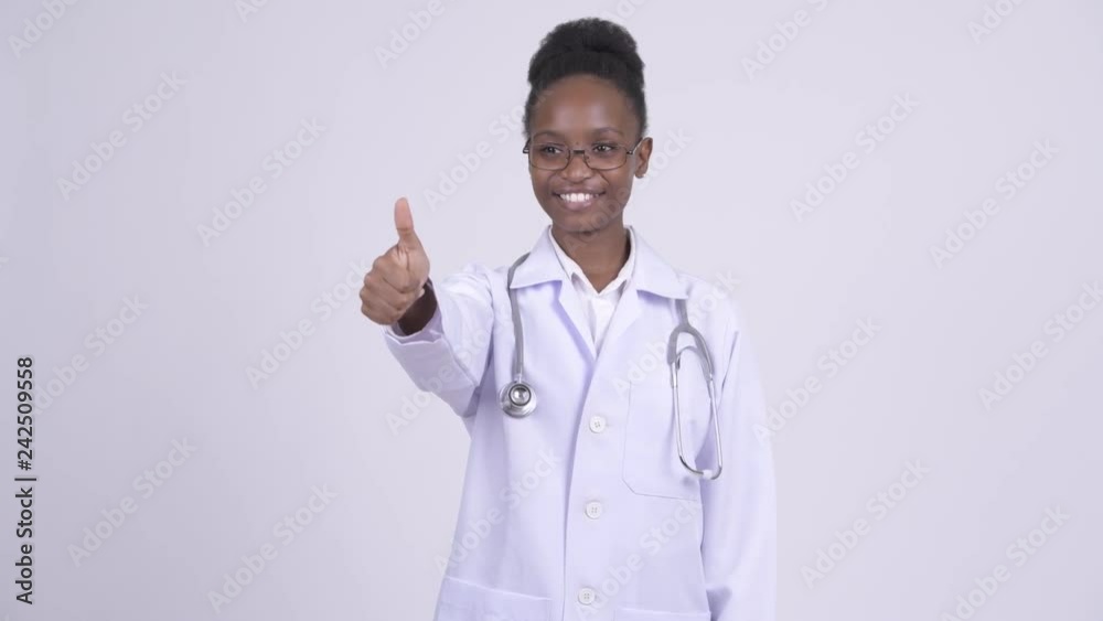 Young happy African woman doctor giving thumbs up Young happy African woman doctor giving thumbs up