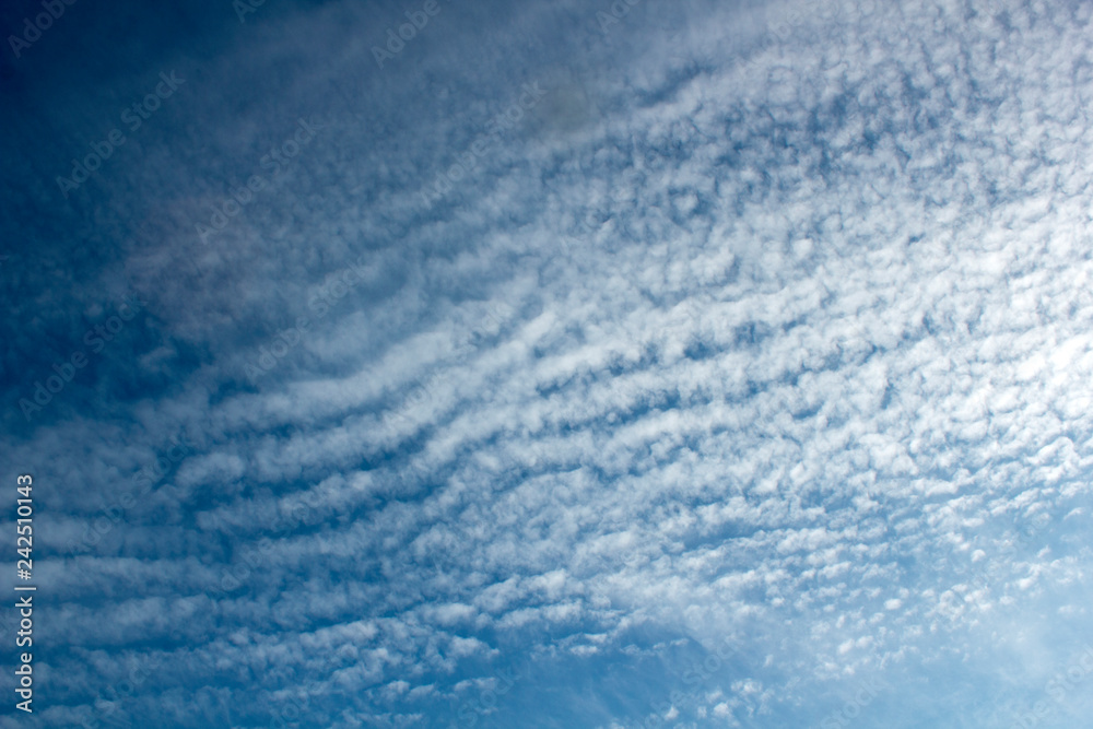 Abstract blue sky with spindrift clouds