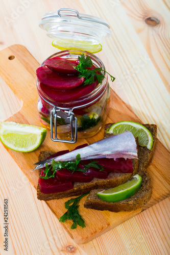 Marinated  poutassou with beets, onions and marinade from lime juice photo