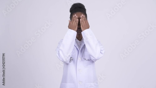 Young African woman doctor covering eyes as three wise monkeys concept