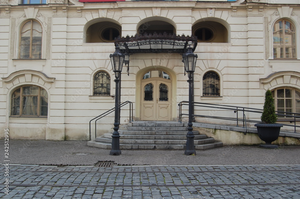 Naklejka premium front view of beautiful old stone building at urban street