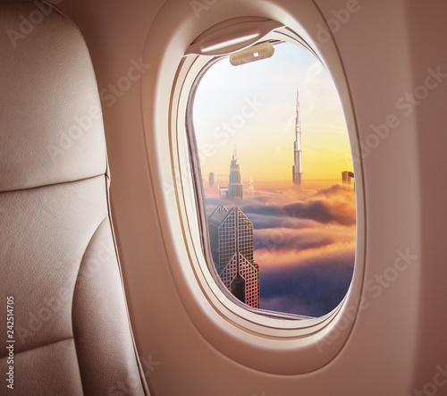 Airplane interior with window view of Dubai city