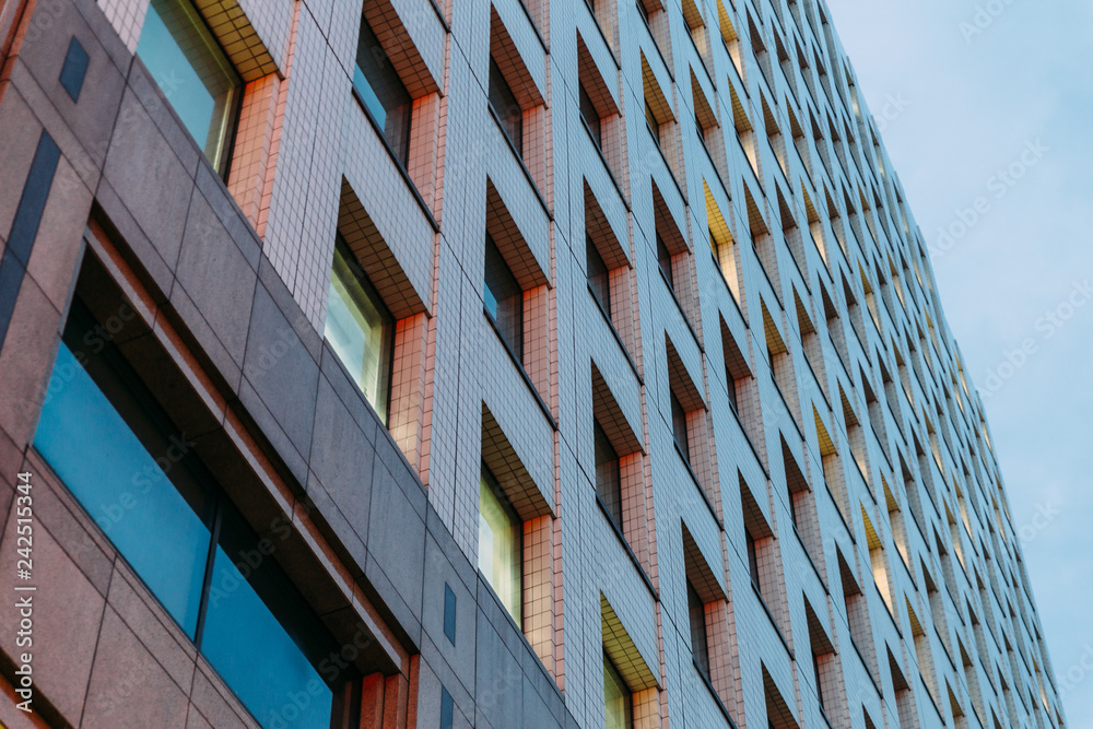 Modern building shot from below with clear sky in background in the evening. Modern building shot from below with clear sky in background in the evening.