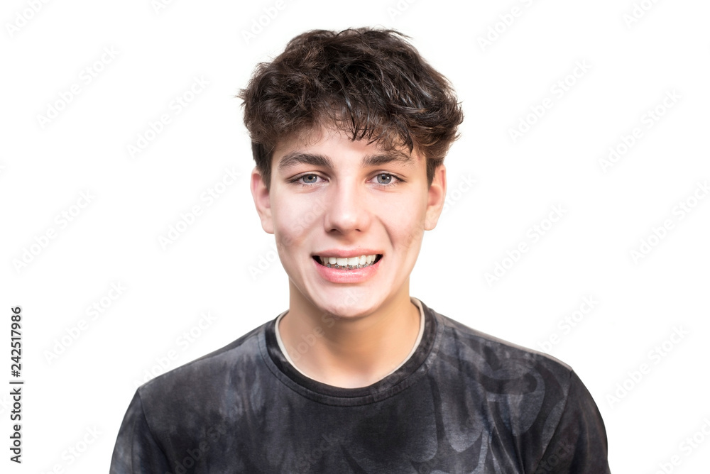 A cute teen with braces on the lower jaw isolated on a white background. Dental concept A cute teen with braces on the lower jaw isolated on a white background. Dental concept