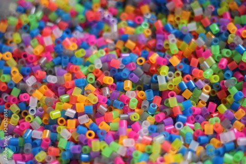 Multicolored background of tubes, cut into small pieces. wandering focus.