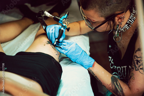 Stylish woman making tattoo photo