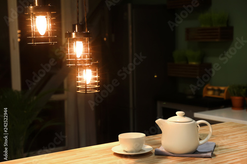 Teapot with cup on wooden t...