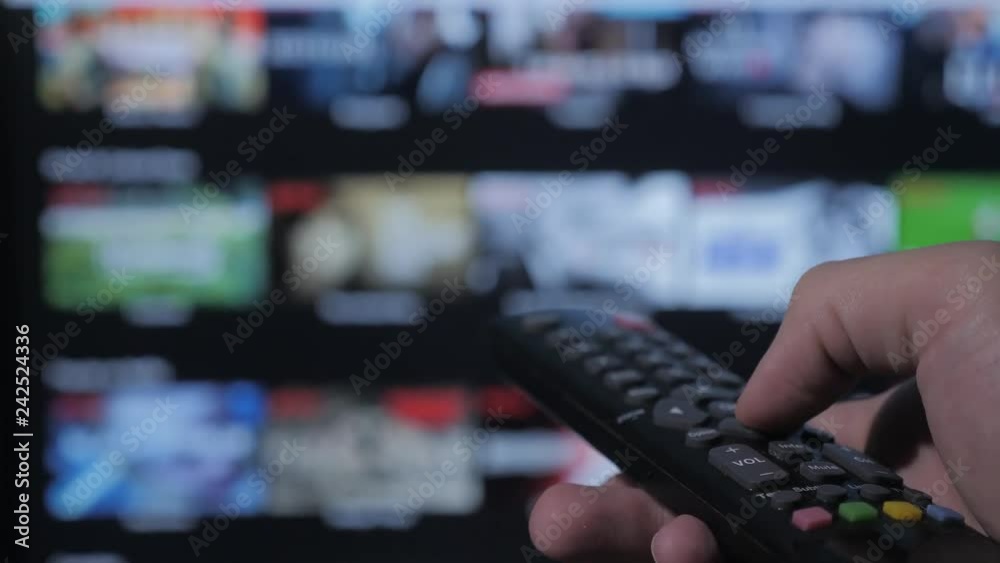 smart tv. online video streaming service. with apps and hand. Male hand holding remote the control turn off lifestyle smart tv . man hand controls holding remote. concept internet lifestyle online smart tv. online video streaming service. with apps and hand. Male hand holding remote the control turn off lifestyle smart tv . man hand controls holding remote. concept internet lifestyle online
