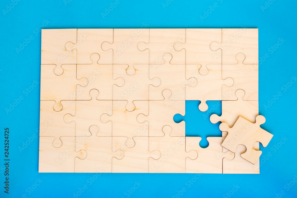 Wooden puzzle on the blue background. Wooden puzzle on the blue background.