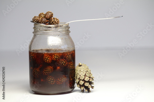 unusual jam from cones, creative for health. forest gifts, sunsets. stocks for the winter. healthy sweets. the bumps next to the jar