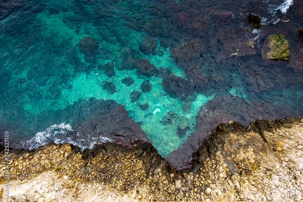 Aerial. Stormy Waves to the Rocky Shore with cristal water in Sicily