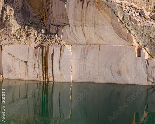 Calm water near stone quarry photo