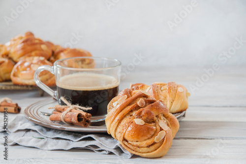 Breakfast: cinnamon buns with a cup of coffee. Horizontal image. Copy space. photo