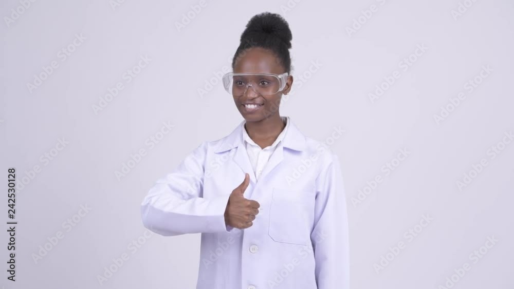 Young happy African woman doctor with protective glasses giving thumbs up Young happy African woman doctor with protective glasses giving thumbs up