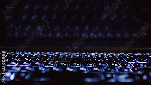 Laptop keyboard and its reflection.