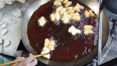 Youtiao, also known as Chinese fried churros, Chinese cruller, Chinese oil stick, Chinese doughnut, You Char Kway/Cakwe/Cakoi/Kueh/Kuay, and fried breadstick photo