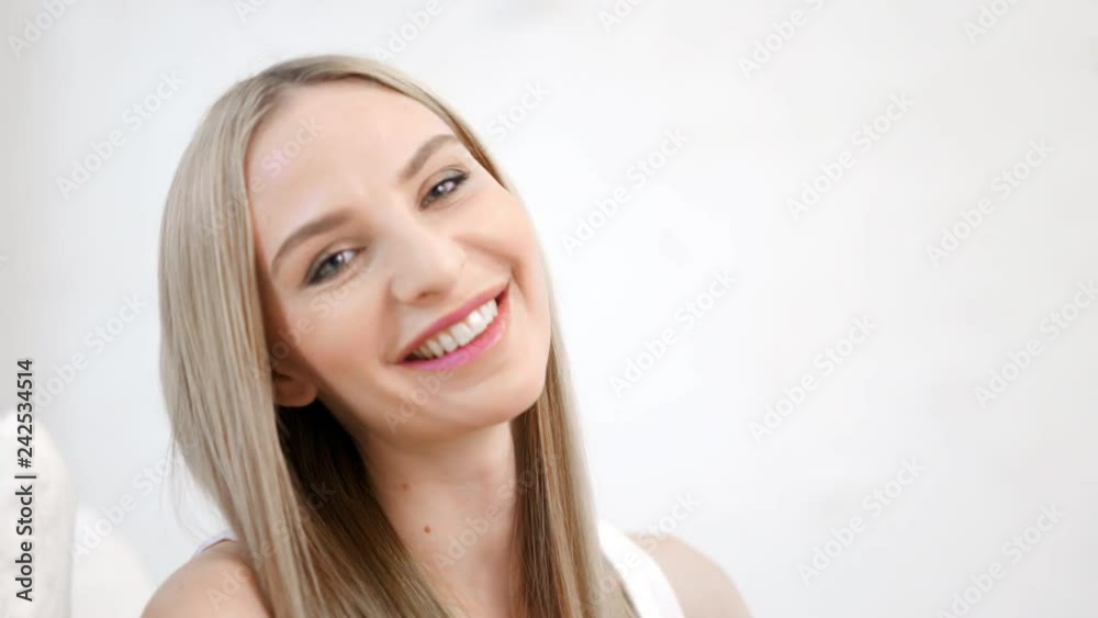 Close-up portrait of sexy smiling beautiful woman flirting and touching hair by hand Close-up portrait of sexy smiling beautiful woman flirting and touching hair by hand