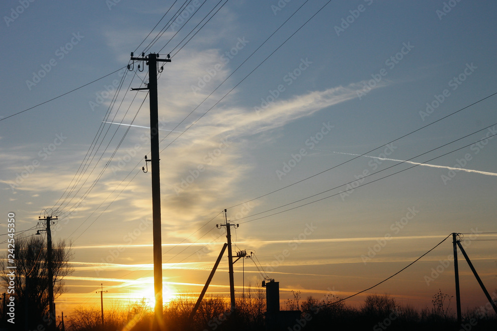 Power grids on the background of the sunset