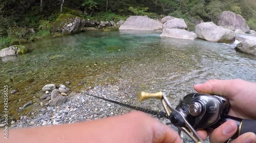 Fishing in a mountain stream for brown trout, pov, Ticino, Switzerland photo