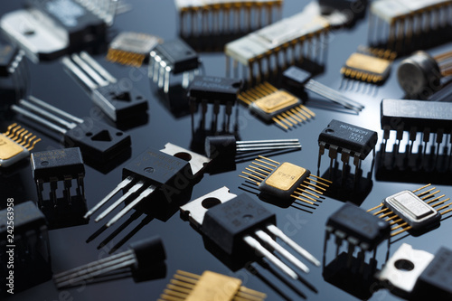 Microelectronic components close-up. Golden electronic microchips.