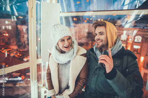 Emotional couple is smiling and looking excited photo