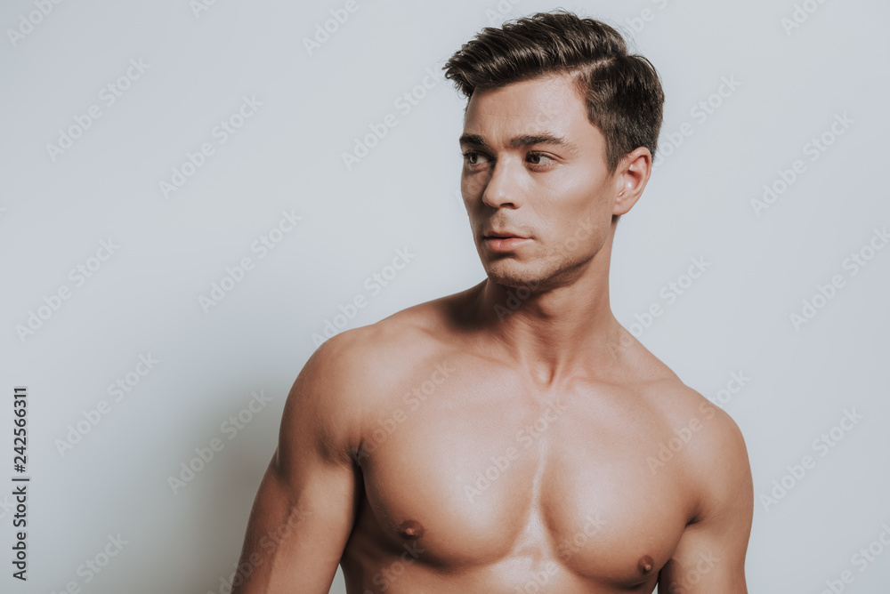 Shirtless masculine young man turning his head to the right Shirtless masculine young man turning his head to the right