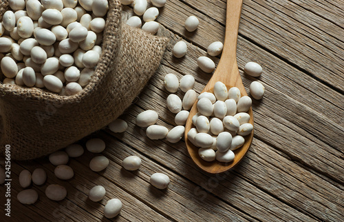 White dried haricot kidney beans on wooden table , heap of legume bean concept. Legumes background
 photo