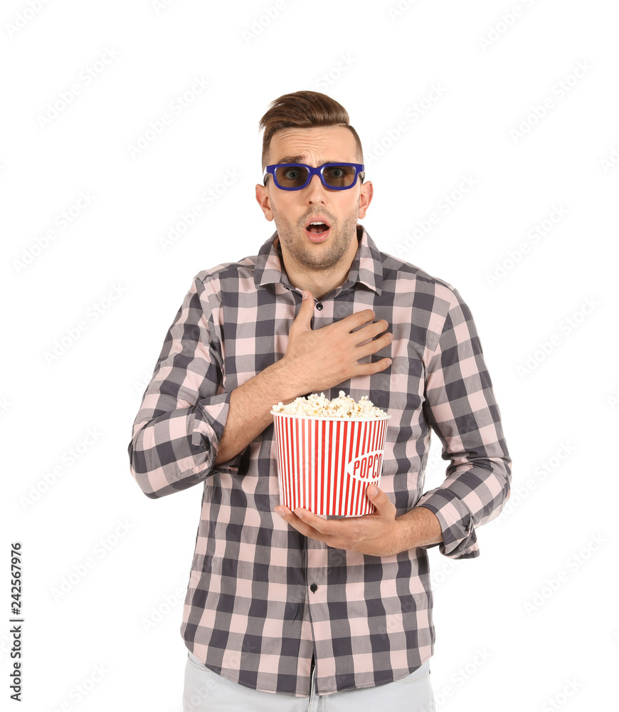 Naklejka premium Emotional man with 3D glasses and popcorn during cinema show on white background