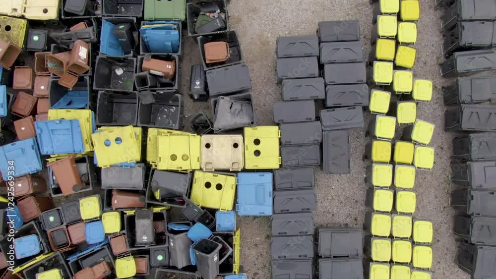 DRONE TOP DOWN Flying away from dumpsters and garbage bins with