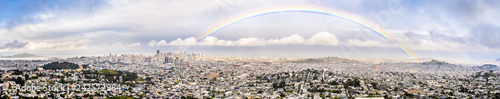 Fotografie, Obraz Panoramic view of San Francisco on a rainy day, rainbow stretching above the cit