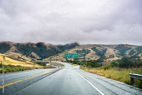 Driving on the highway through the hills of south San Francisco bay area on a cloudy day, California photo