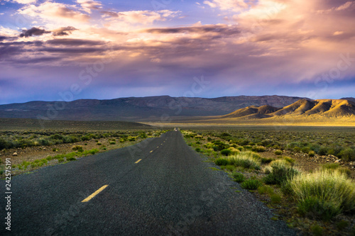 Εκτύπωση καμβά Sunset light illuminating Emigrant Canyon road, Death Valley National Park, Cali