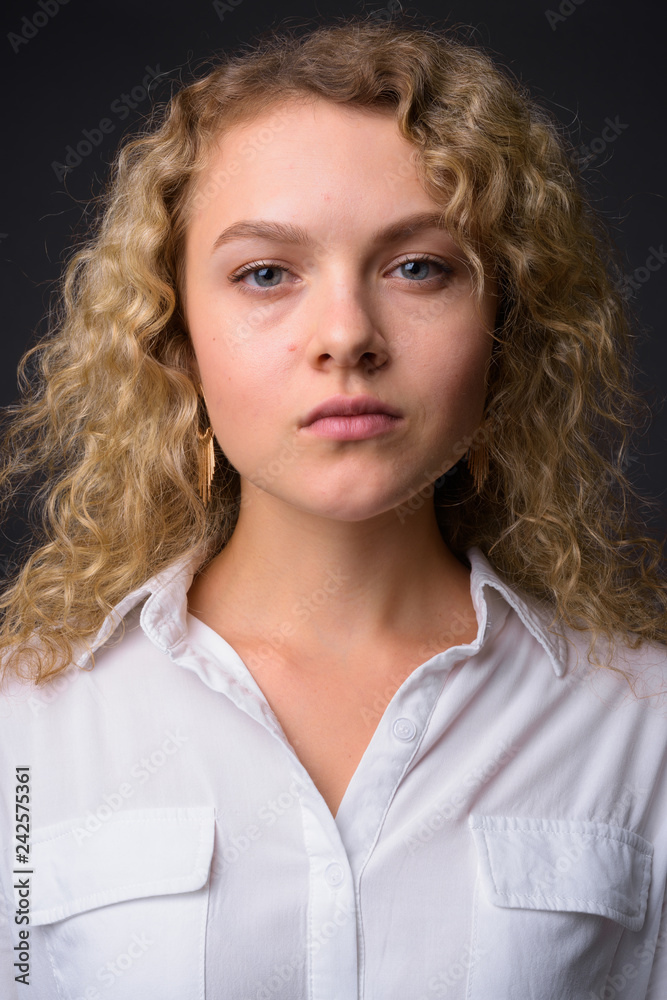 Face of young beautiful businesswoman with curly blond hair Face of young beautiful businesswoman with curly blond hair
