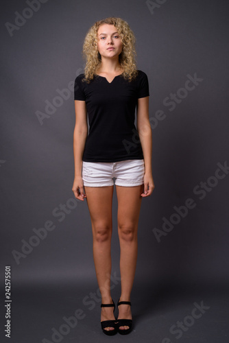 Full length portrait of young beautiful woman standing