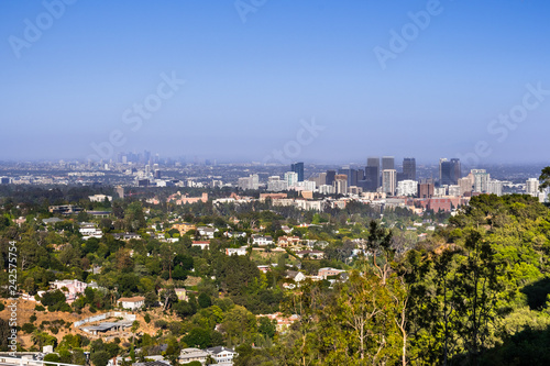 Aerial view towards the skyline of Century City commercial district; the downtown area skyscrapers visible in the background; residential neighborhood in the foreground; Los Angeles, California