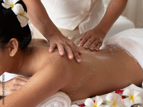 Show Hands moving blur of masseuse while body scrub. Salt Scrub Beauty Treatment in the Health Spa.