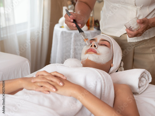 Beautiful young asian woman with facial mask at beauty spa salon. Beauty Treatments