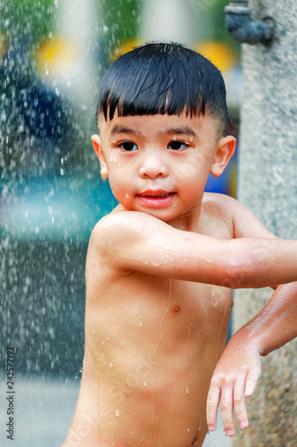 Kid boy playing with water during take shower © nitimongkolchai