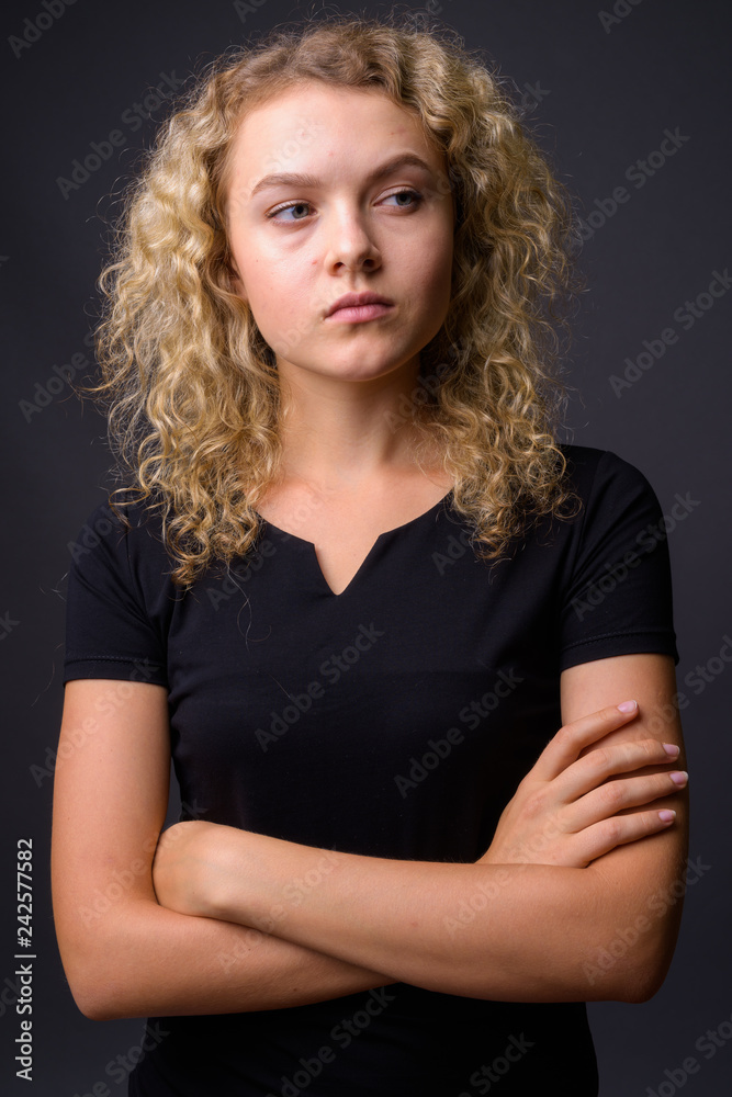 Portrait of young beautiful woman with curly blond hair