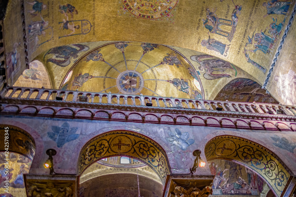 Interior ceiling view of St. Mark's Basilica in Venice with beautiful artwork, mosaics, painting, dome and arches